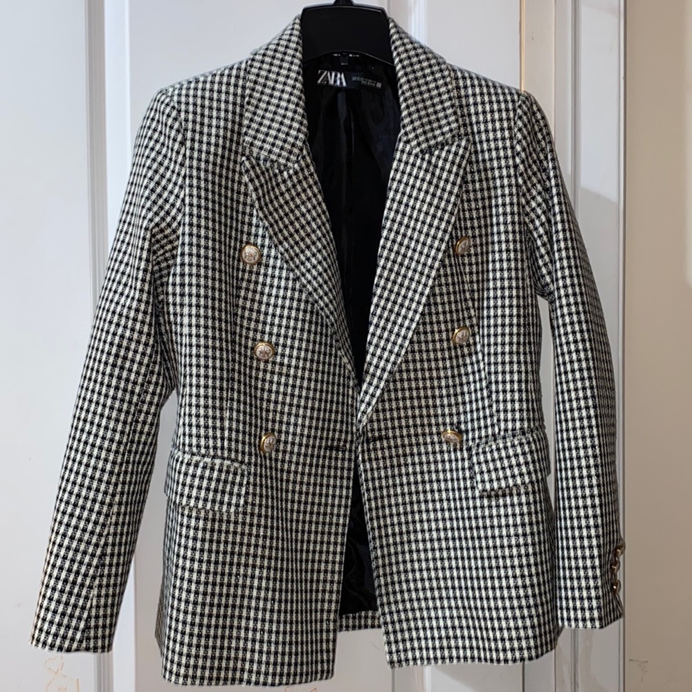 Black and white blazer with buttons. Was torn on the inside and then sewed up.